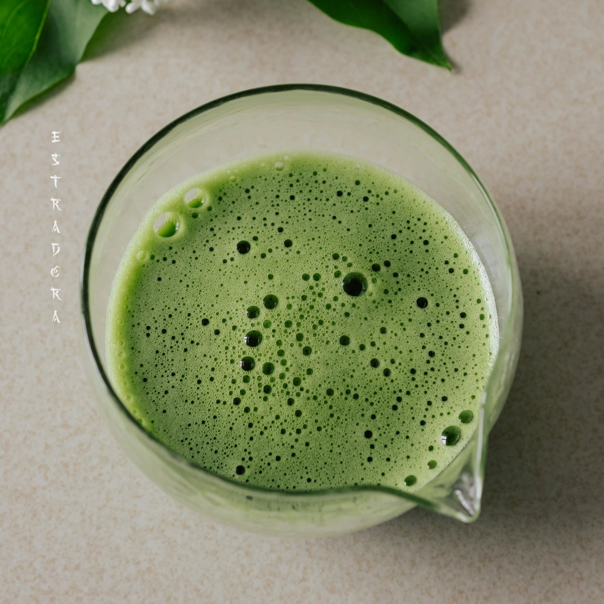 Freshly whisked Japanese Matcha OKA in glass bowl with creamy froth