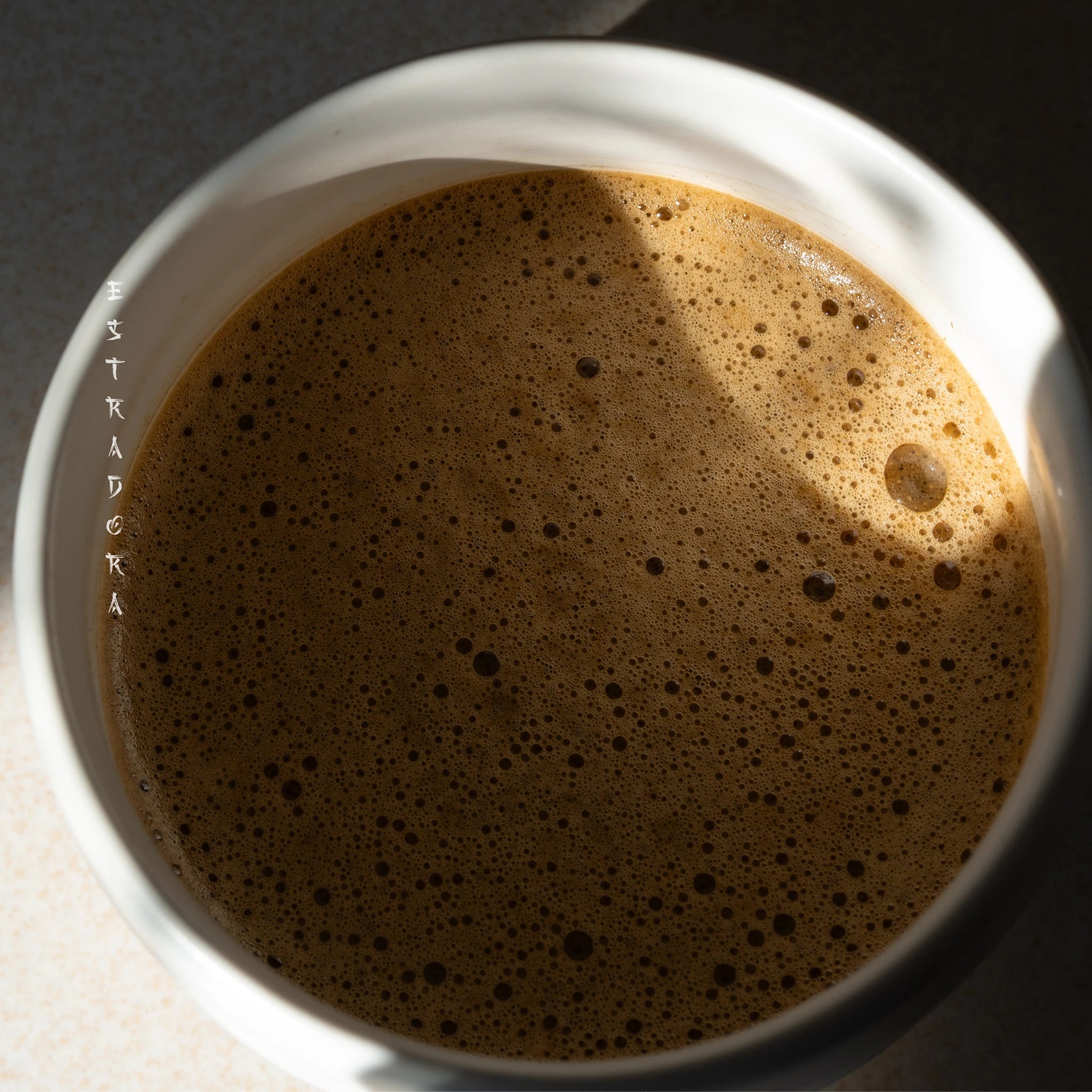 Brewed Wakoucha Powder tea in a white ceramic bowl with foam, close-up view