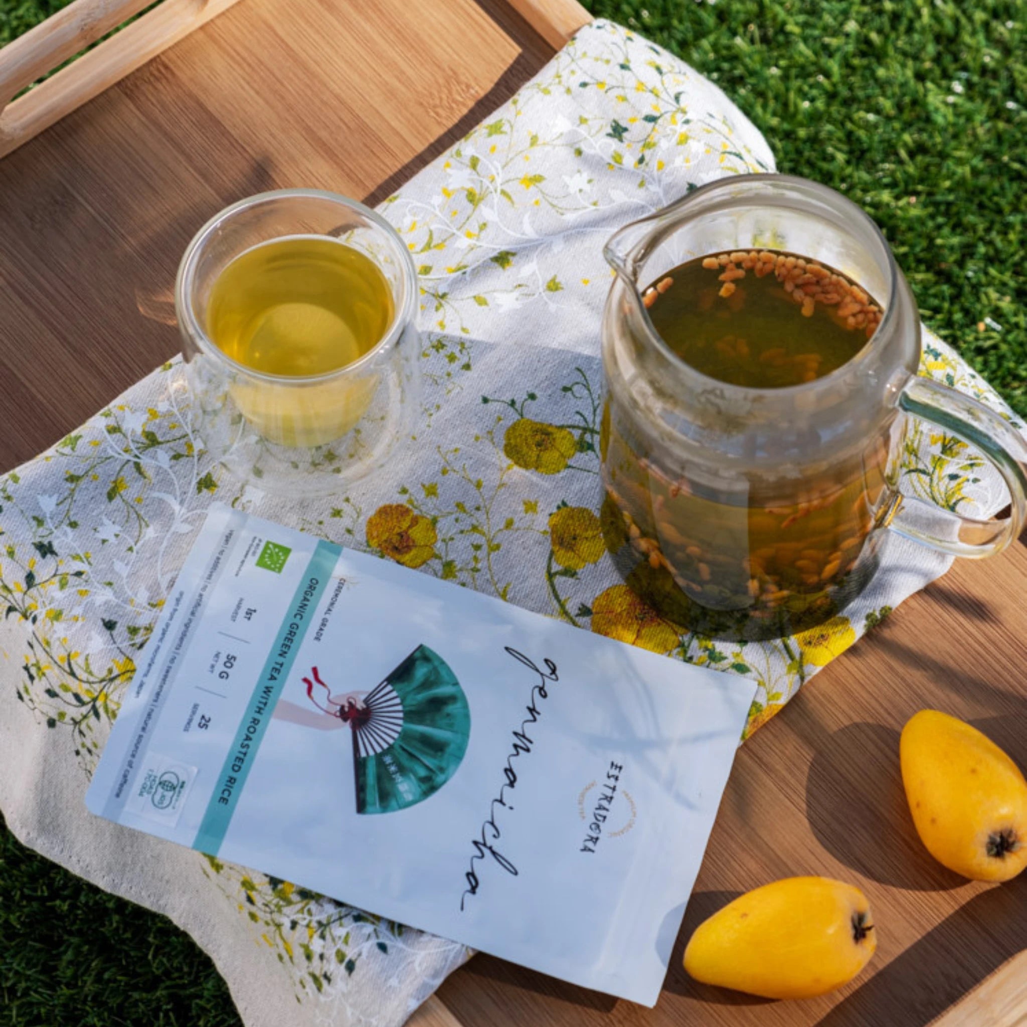 Japanese Genmaicha tea package with brewed tea, outdoor picnic scene
