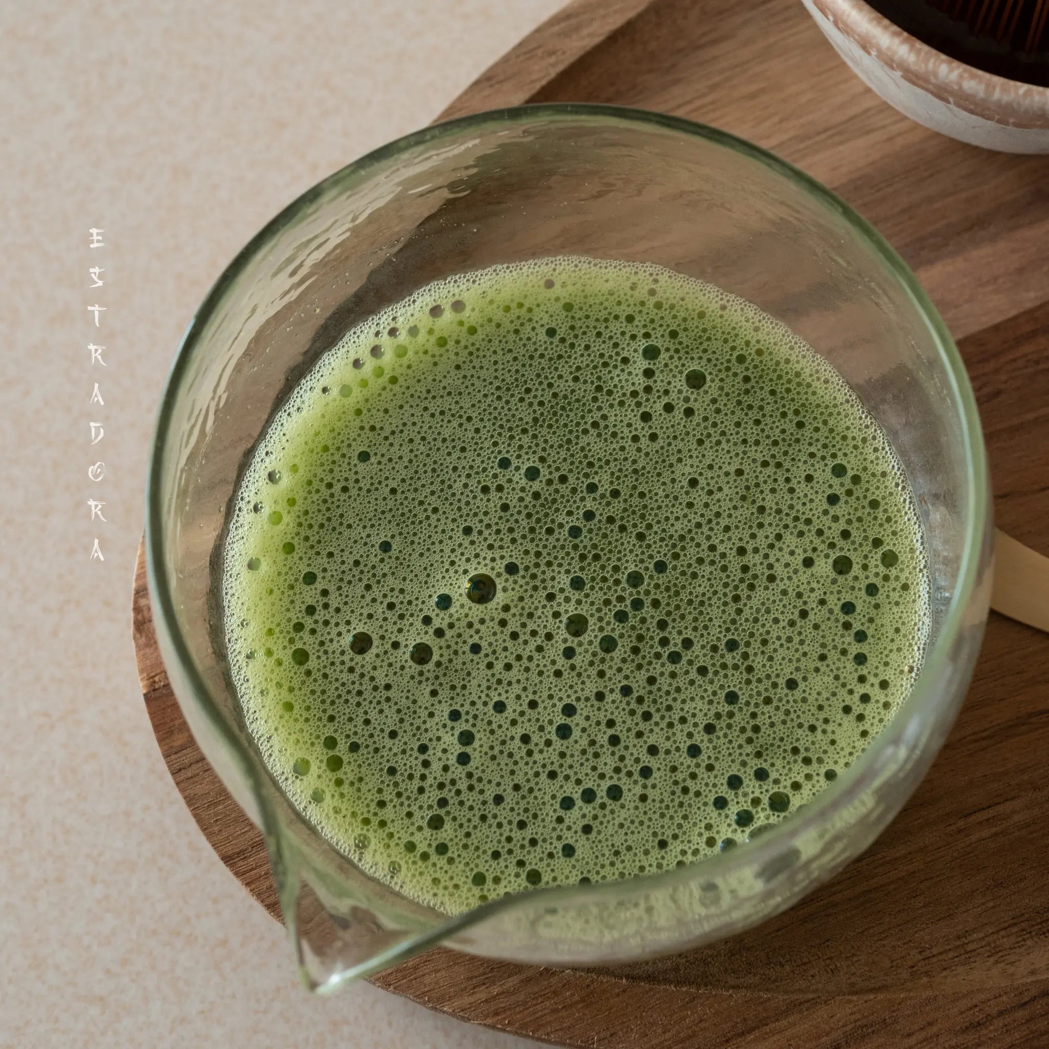 Freshly whisked Genmaicha tea in glass cup. Japanese Genmaicha tea powder by Estradora