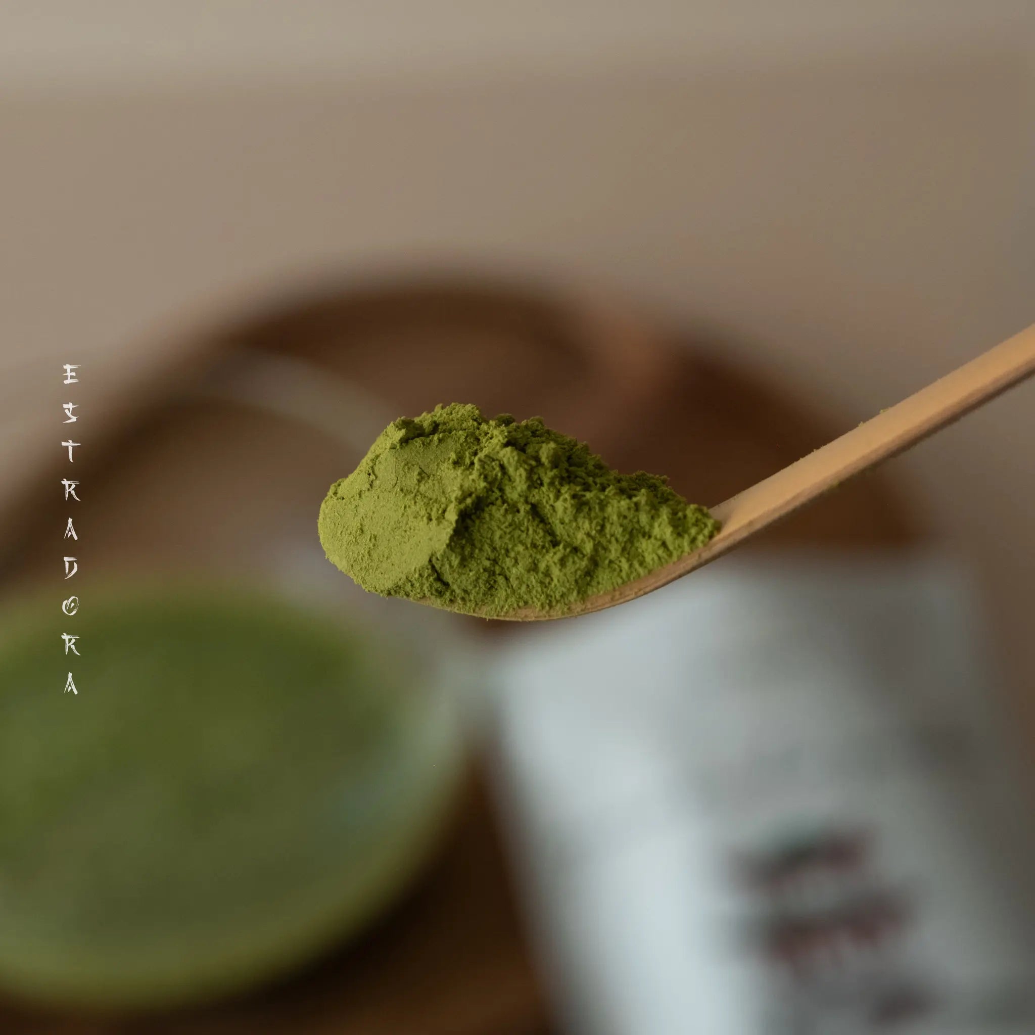 Close-up of Japanese Genmaicha green tea powder on bamboo spoon –  ceremonial blend by Estradora