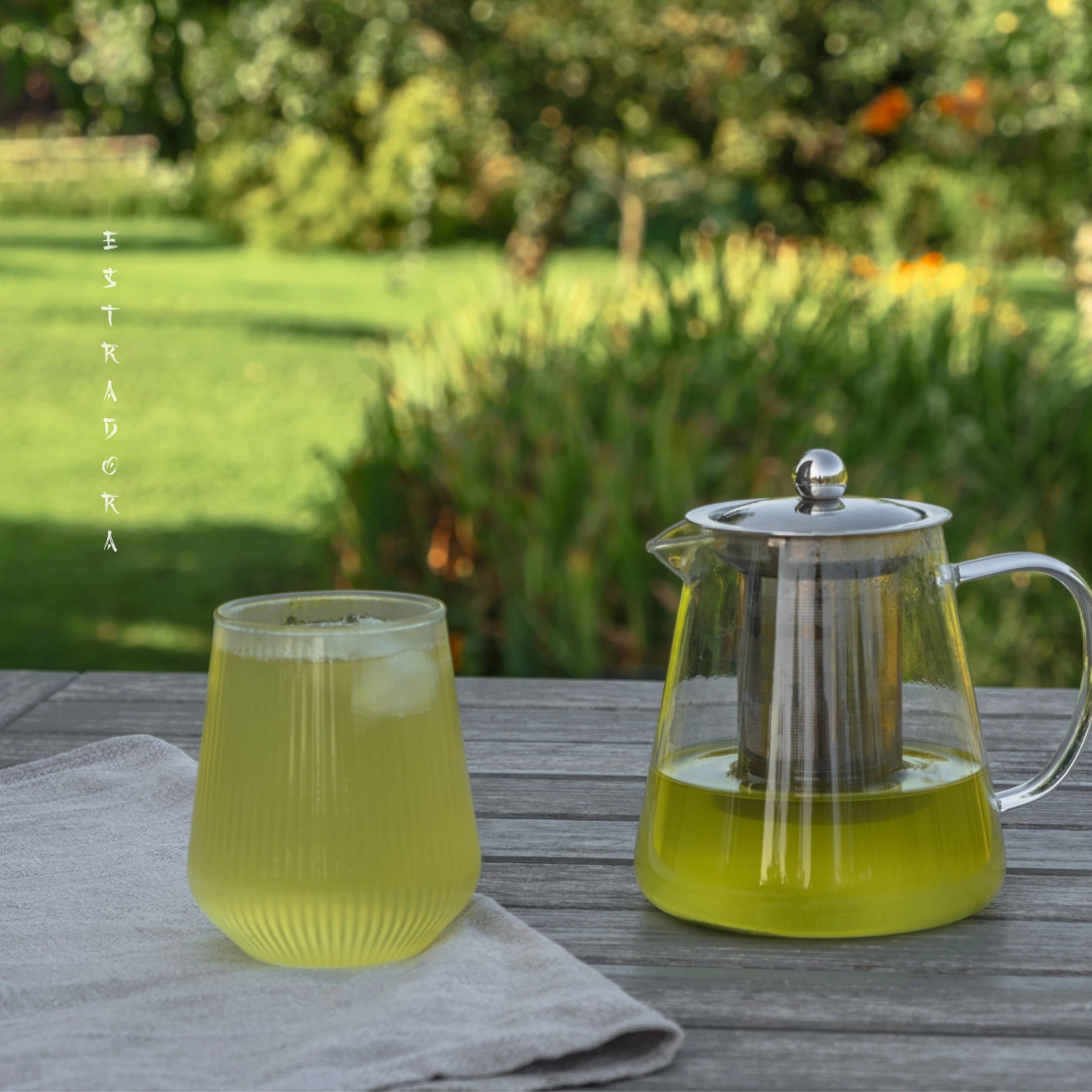 Japanese Oolong green tea served iced in glass cup and glass teapot outdoors – refreshing ceremonial green tea - Estradora